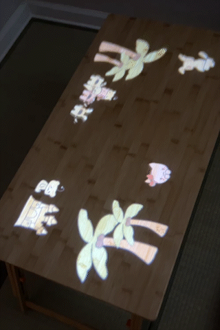 Bibi and friends searching around the beach for the elderly dragon projected onto a table