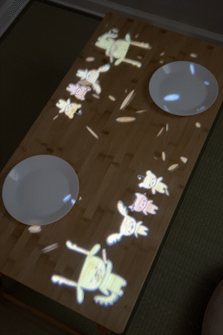 Ending celebration scene where the elderly dragon makes it rain orange blossoms projected onto a table