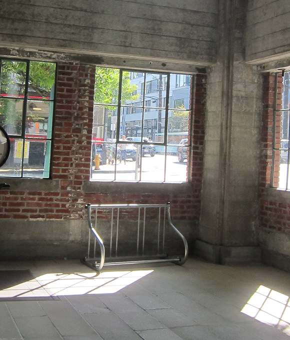 CD cover featuring brutalist architecture with light shining through a window