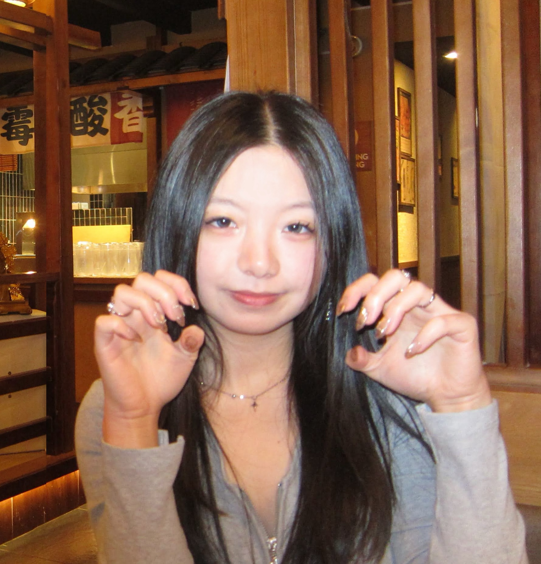 Emilee striking a cat pose in front of a traditional ancient Chinese style restaurant